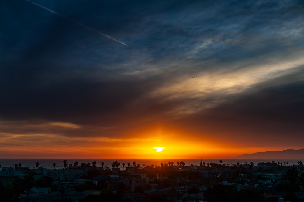 city skyline under blue sky during sunset