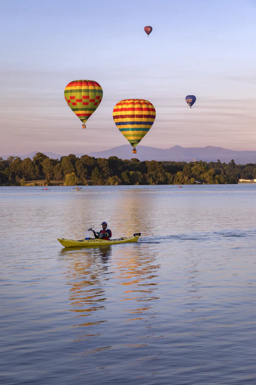Two people out on a boat on the water in Canberra during the day