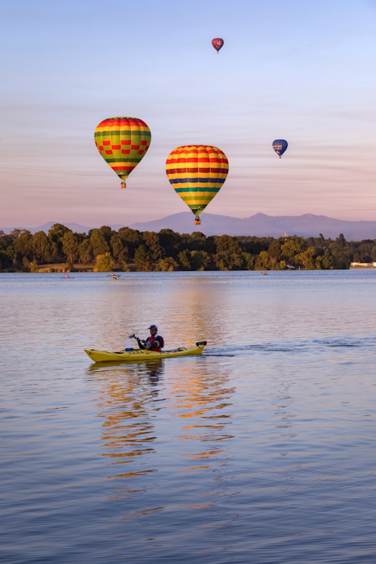 2 people riding on boat on water during daytime in Canberra ACT Australia