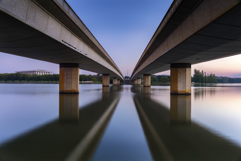 brown wooden bridge over water under blue sky during daytime