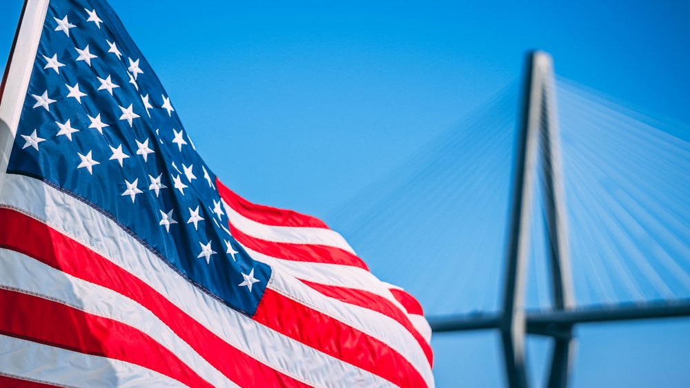 us a flag on pole during daytime