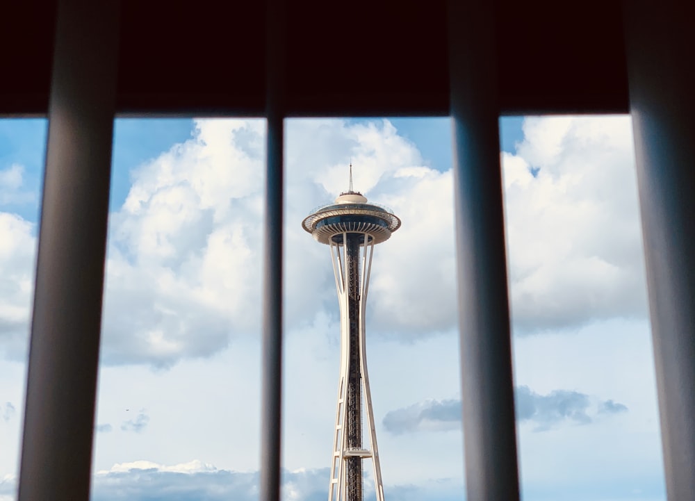 a view of the space needle from behind bars