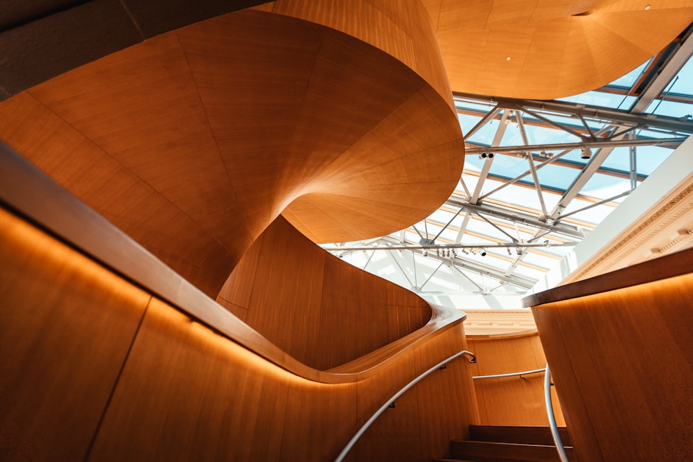 brown spiral staircase with white metal railings