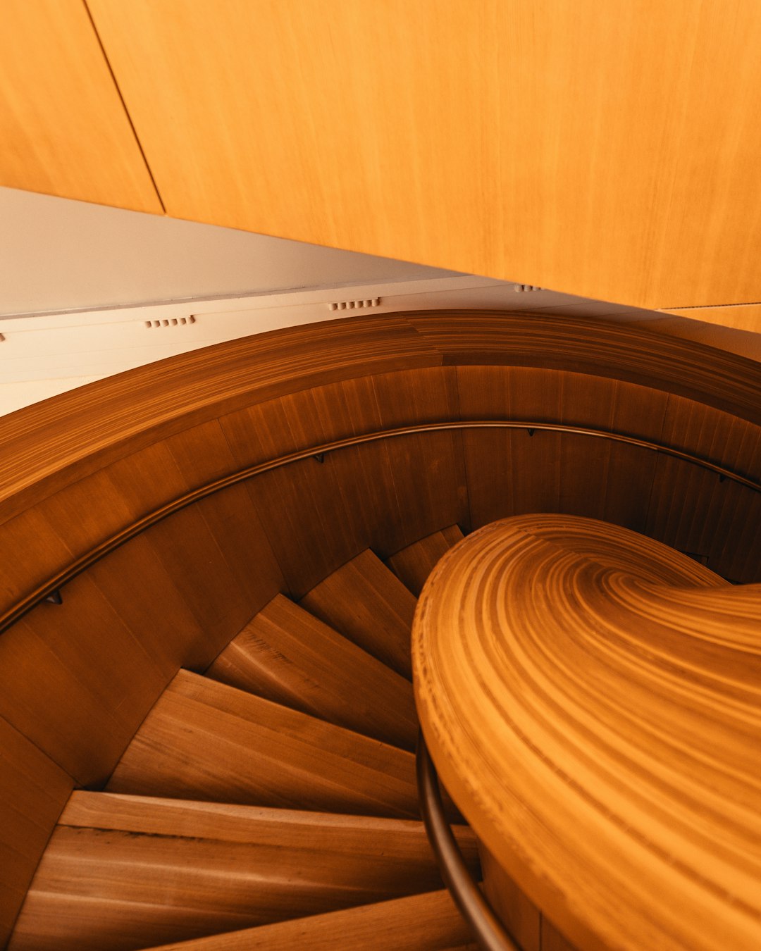 brown wooden spiral staircase with white paper