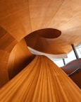 brown wooden spiral staircase with white wooden frame