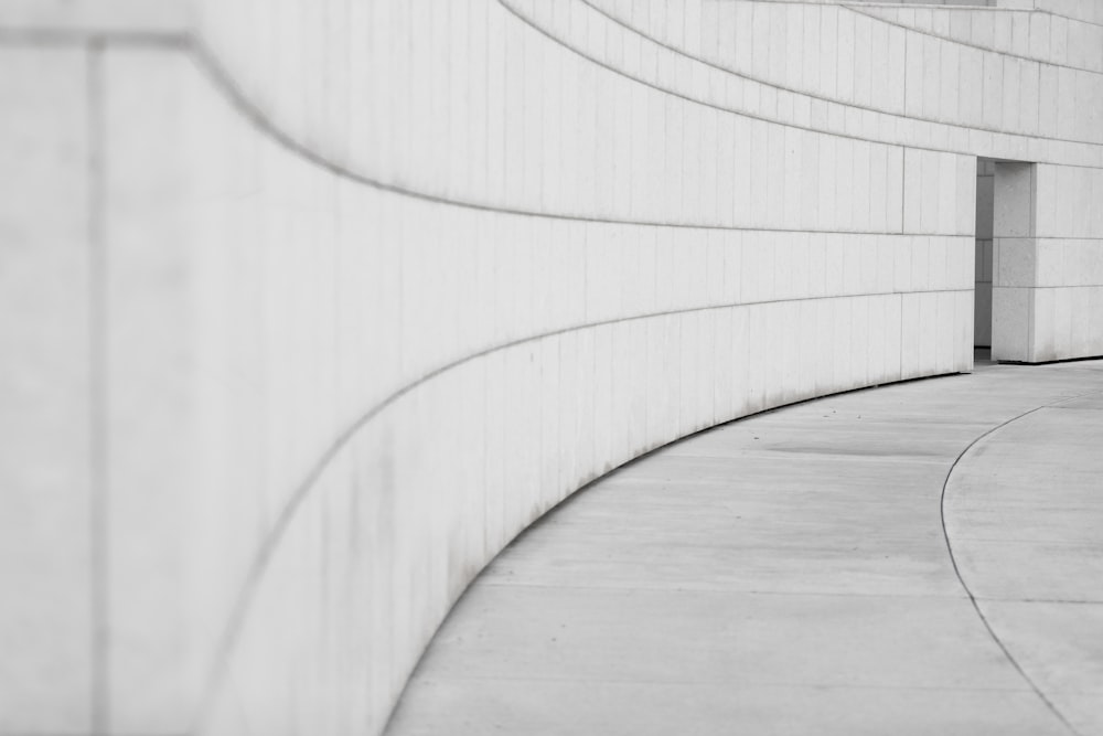 grayscale photo of wooden pathway