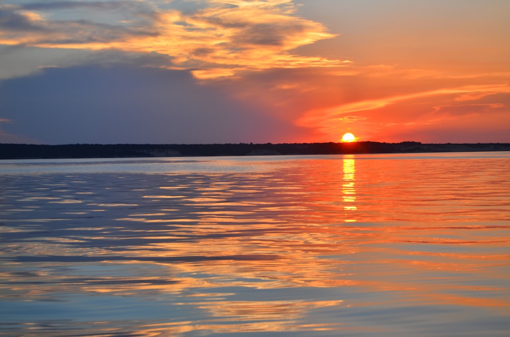 body of water during sunset