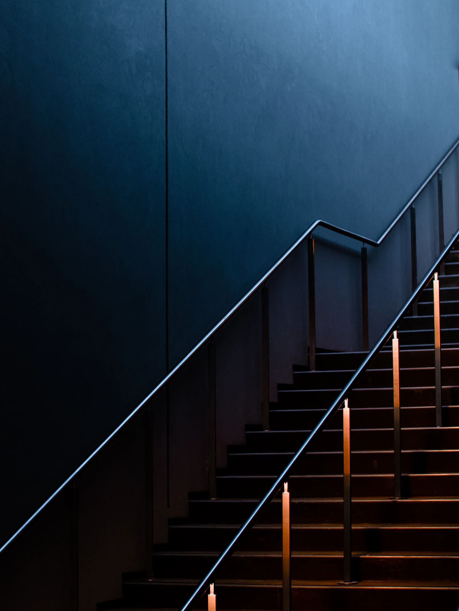 Black staircase with stainless steel railings