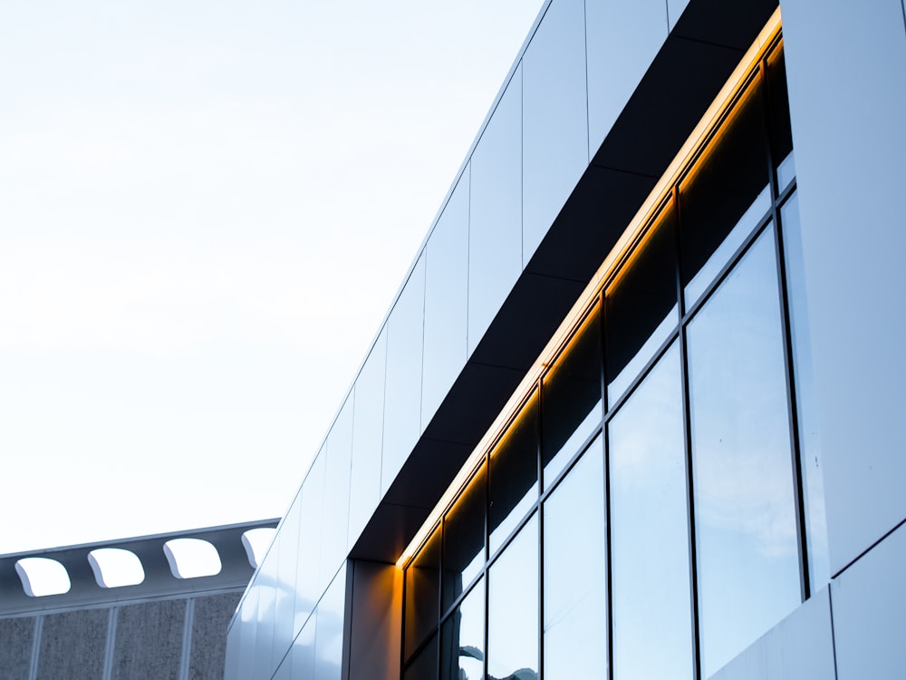 glass walled building under white sky during daytime