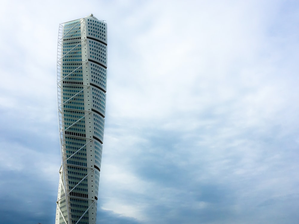 white and black building under white clouds