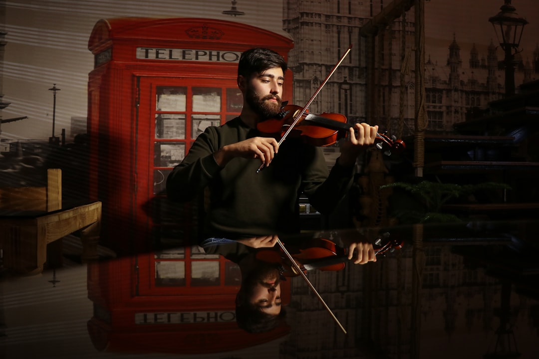 man in black long sleeve shirt playing violin