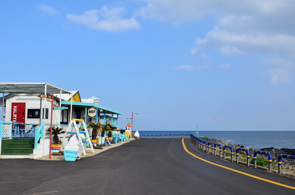 white and blue wooden house near body of water during daytime