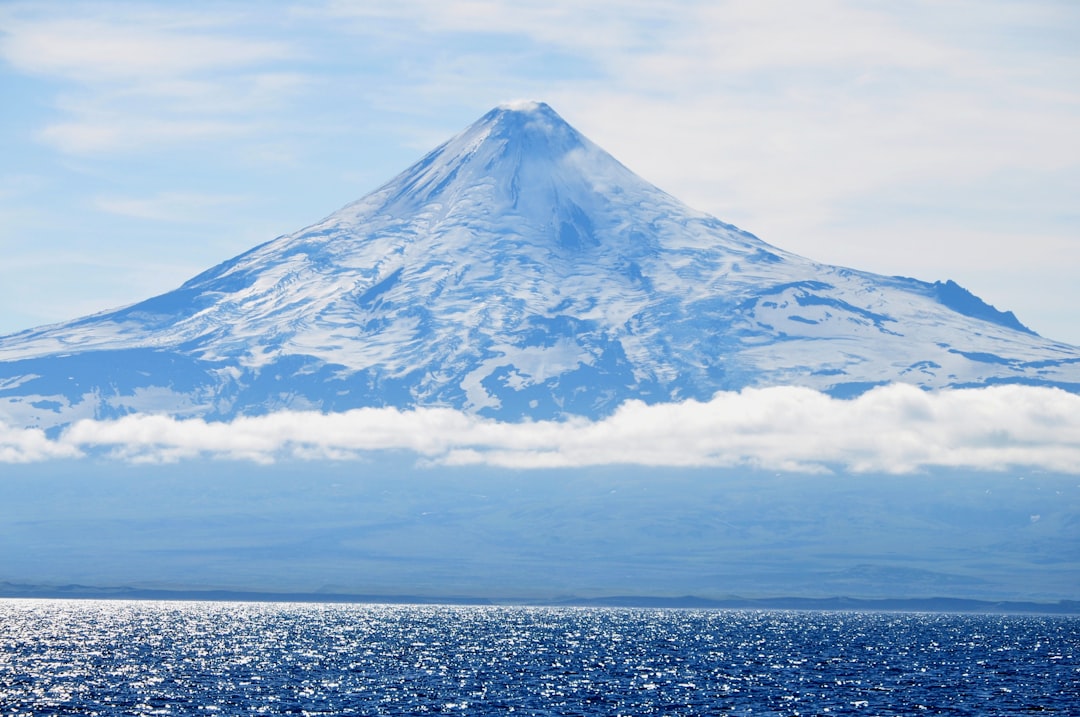 white and black mountain under white clouds during daytime