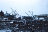 grayscale photo of wrecked ship on shore