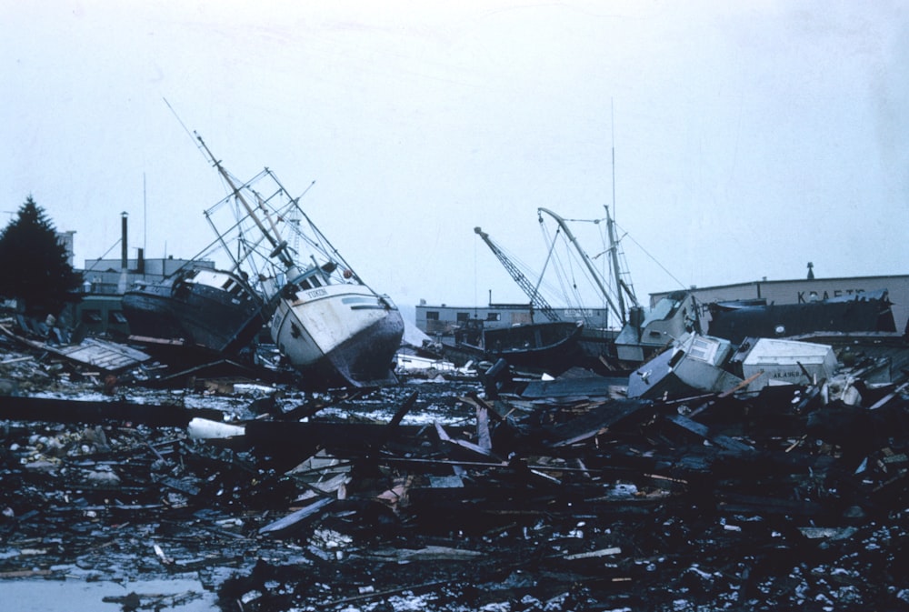 grayscale photo of wrecked ship on shore