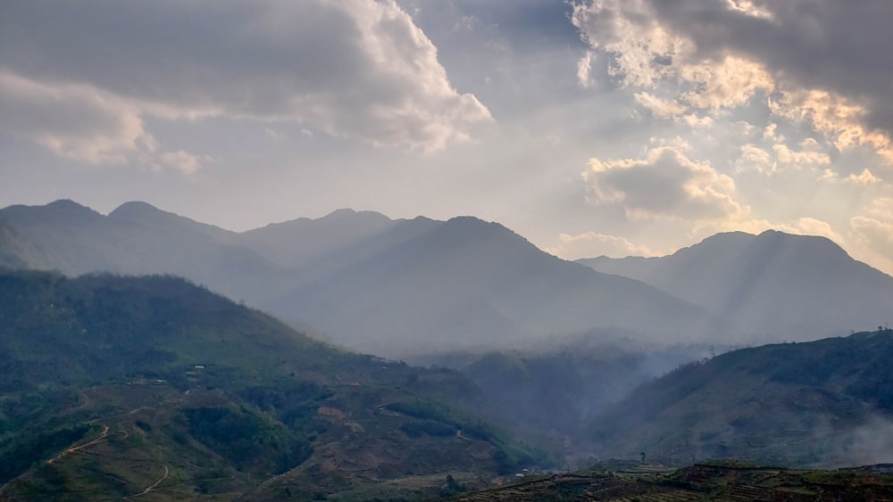 green mountains under white clouds during daytime