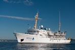 white and blue ship on sea under blue sky during daytime