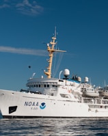 white and blue ship on sea under blue sky during daytime