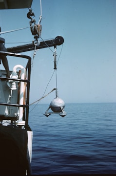 black and white fishing rod on brown wooden post