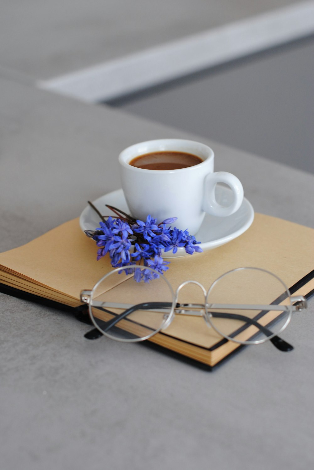 white ceramic mug with coffee on brown wooden table