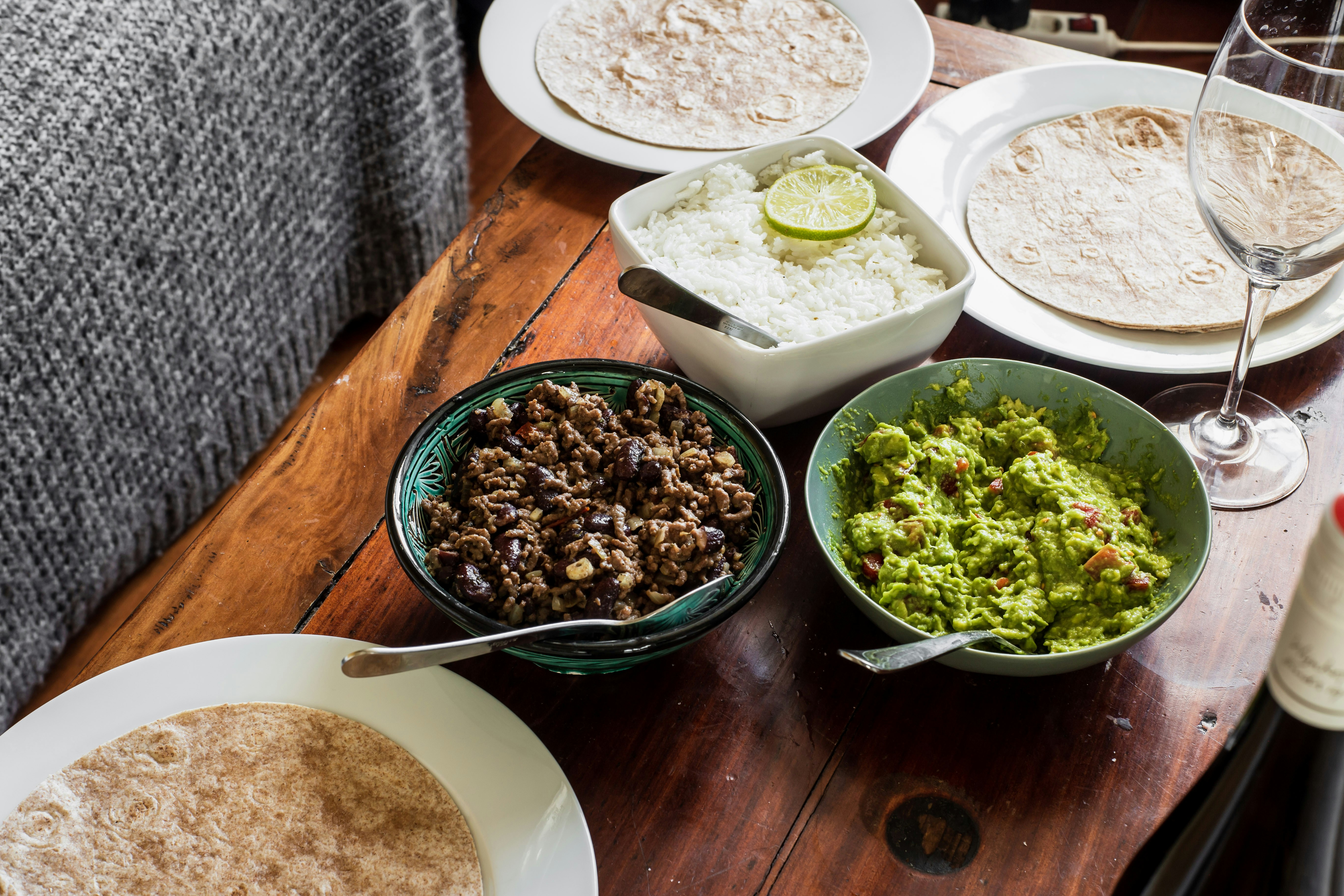green and white ceramic bowls on brown wooden table