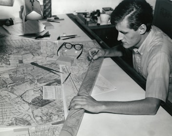 man writing on white paper