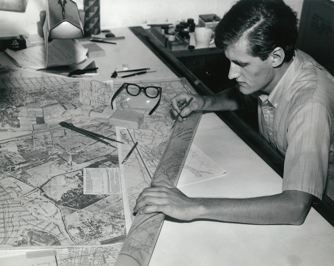 man writing on white paper