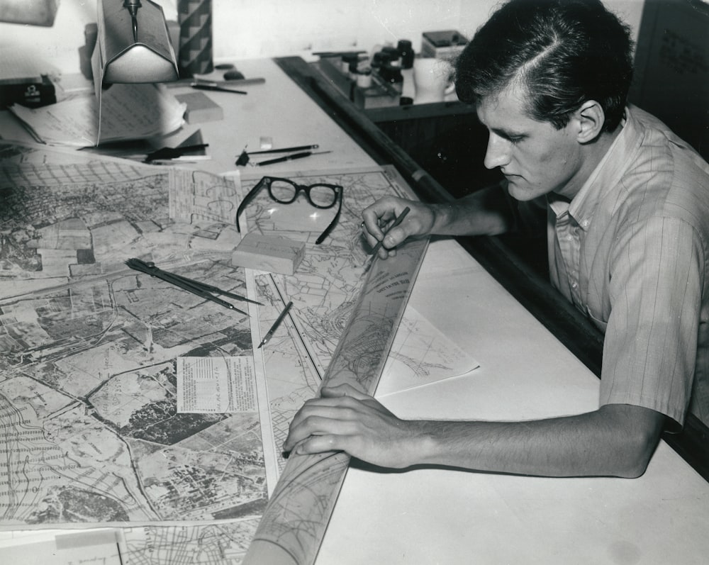 man writing on white paper