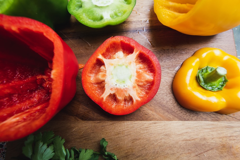 sliced tomato and green leaves on brown wooden table