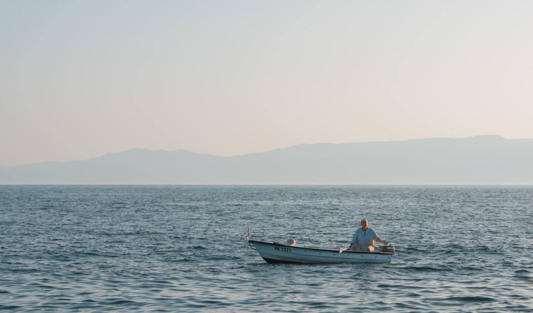 2 people riding on boat on sea during daytime