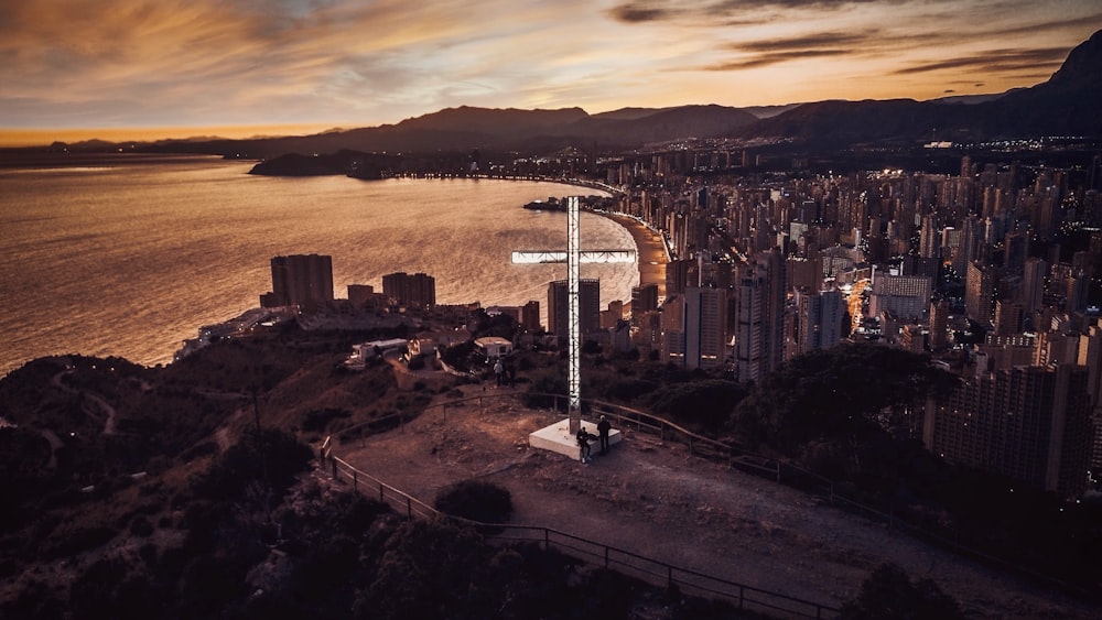 white and black street lamp near city buildings during sunset