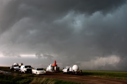 A fleet of powerful trucks lined up under a dramatic sky, ready to hit the road.