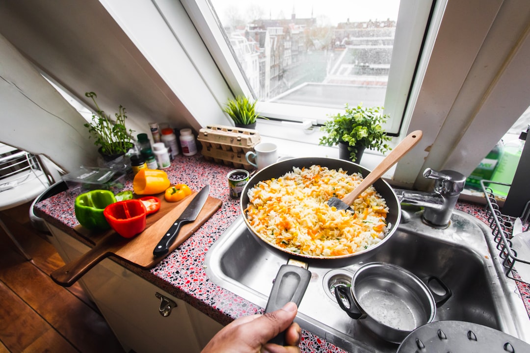 person cooking food on pan