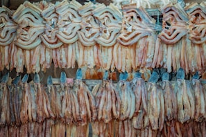 Artisan workers inspecting dried fish with precision in a clean, bright facility