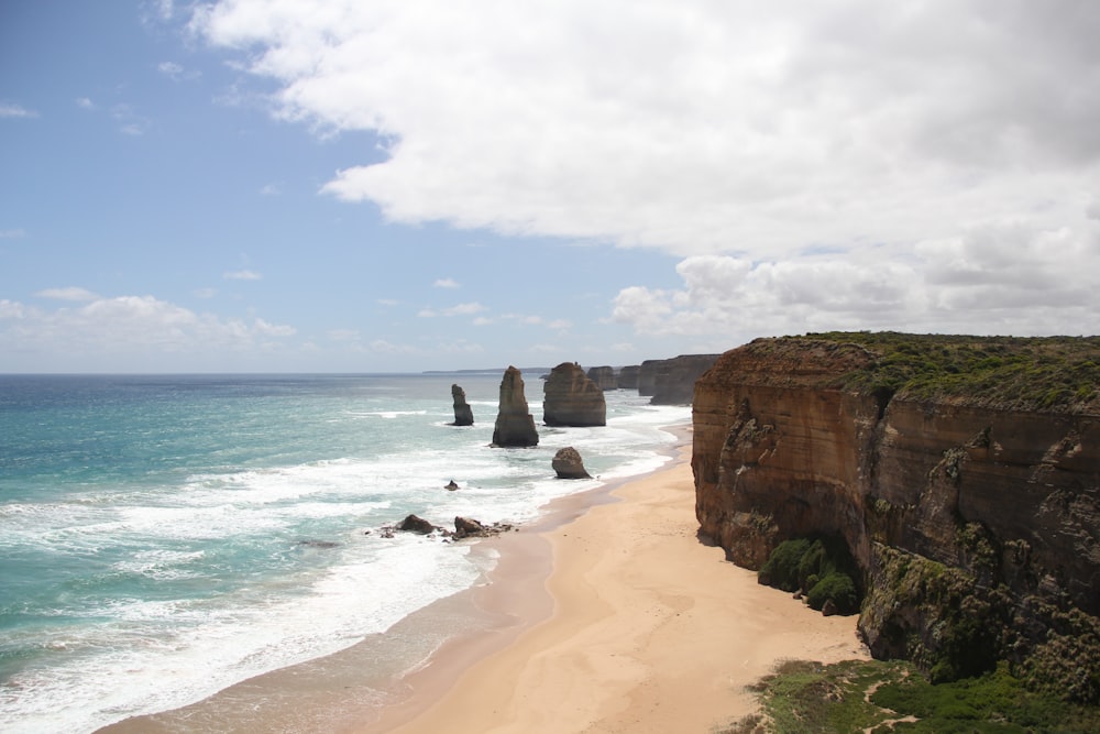 brown rock formation on sea shore during daytime