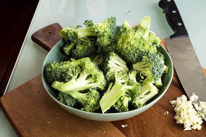 Fresh broccoli florets in a white bowl