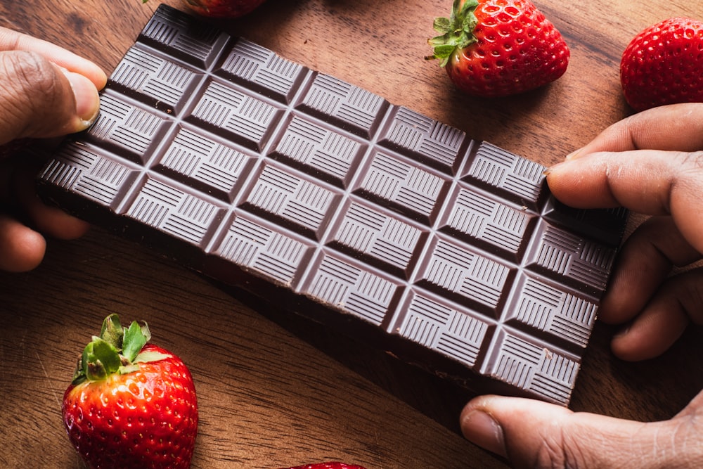 red strawberry on brown wooden table