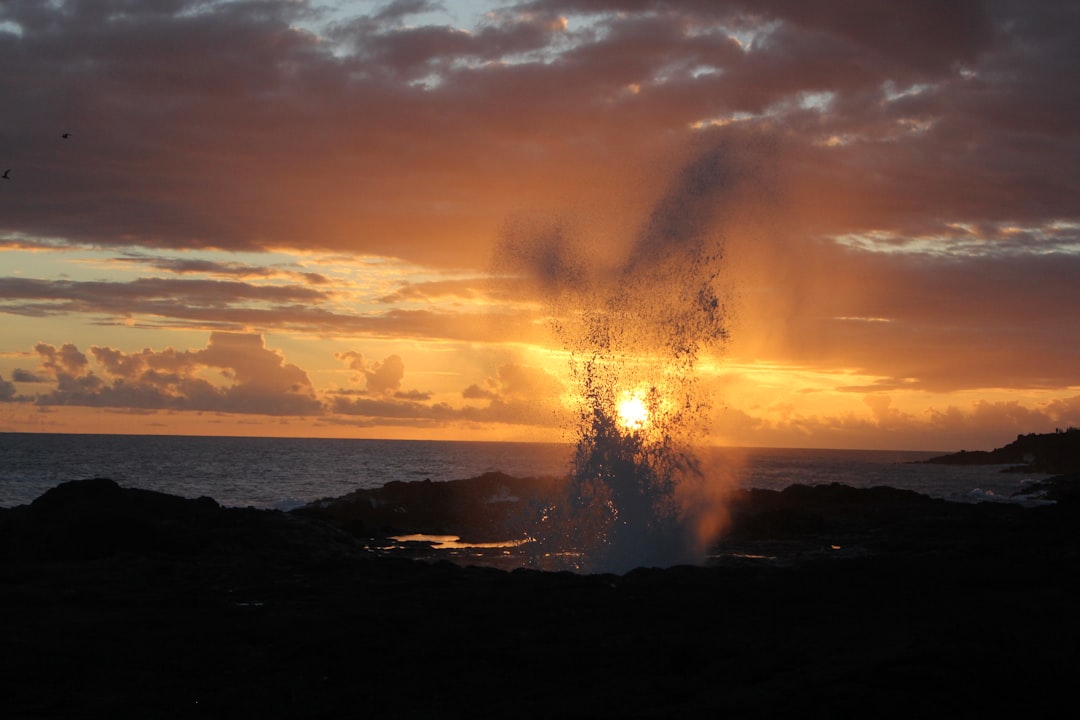 sea waves crashing on shore during sunset