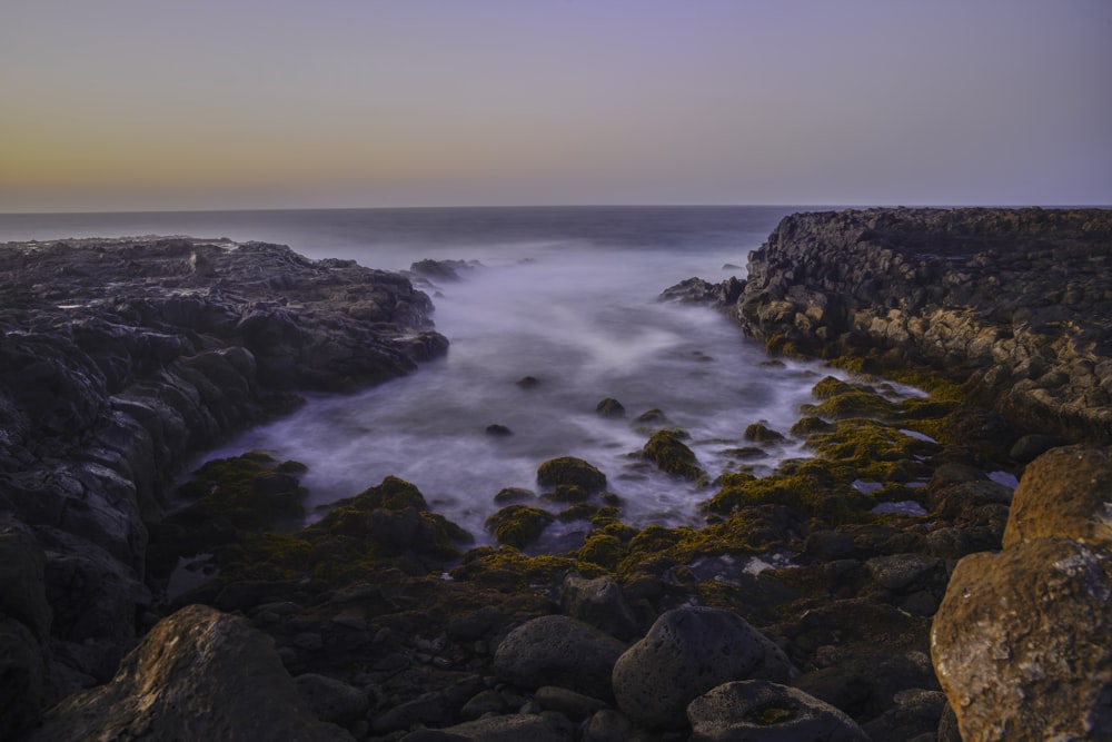 rocky shore with ocean waves during daytime