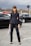 woman in black blazer and black pants standing on road during daytime