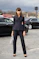woman in black blazer and black pants standing on road during daytime
