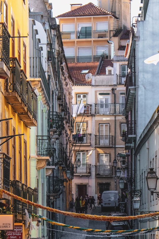yellow and white concrete buildings during daytime in Bairro Alto Portugal