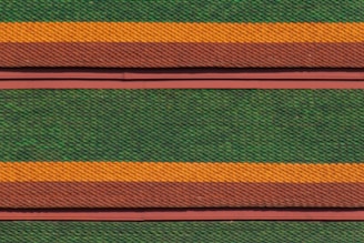 Rows of roof tiles are arranged in a detailed, repetitive pattern featuring alternating colors of green, orange, and brown. The tiles have a scale-like texture, creating a visually striking and textured appearance.