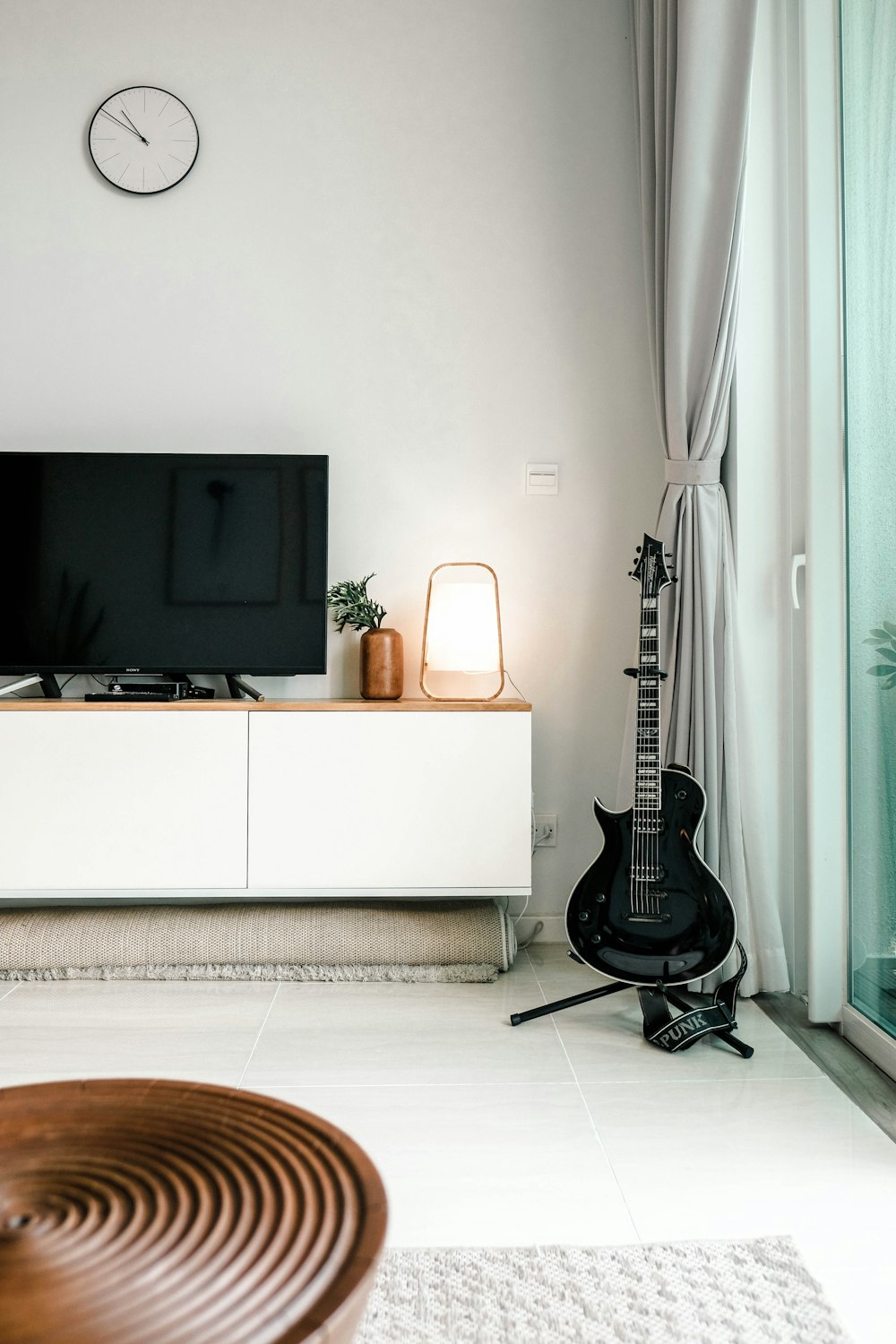 black flat screen tv on white wooden tv rack