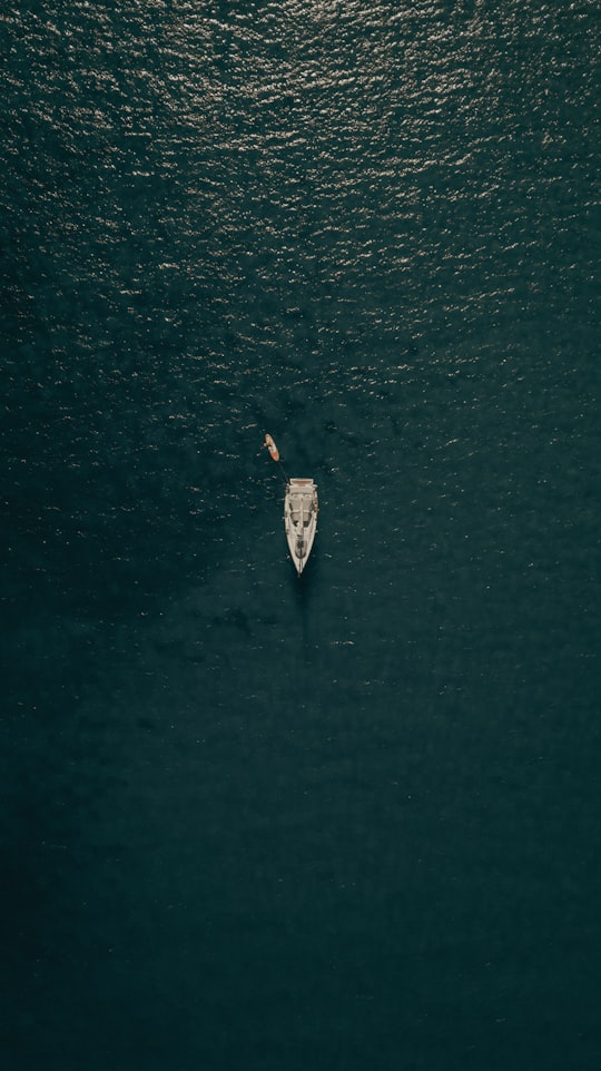 aerial view of person in white shirt riding on white boat on water during daytime in Portoferraio Italy