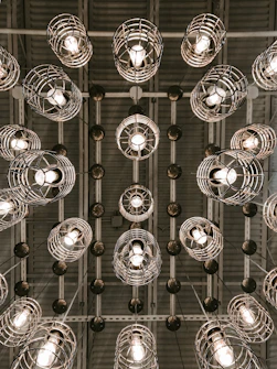 silver round pendant lamps turned on in grayscale photography