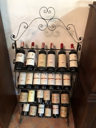 A sleek stainless steel wine rack holding several bottles in a cozy kitchen corner.