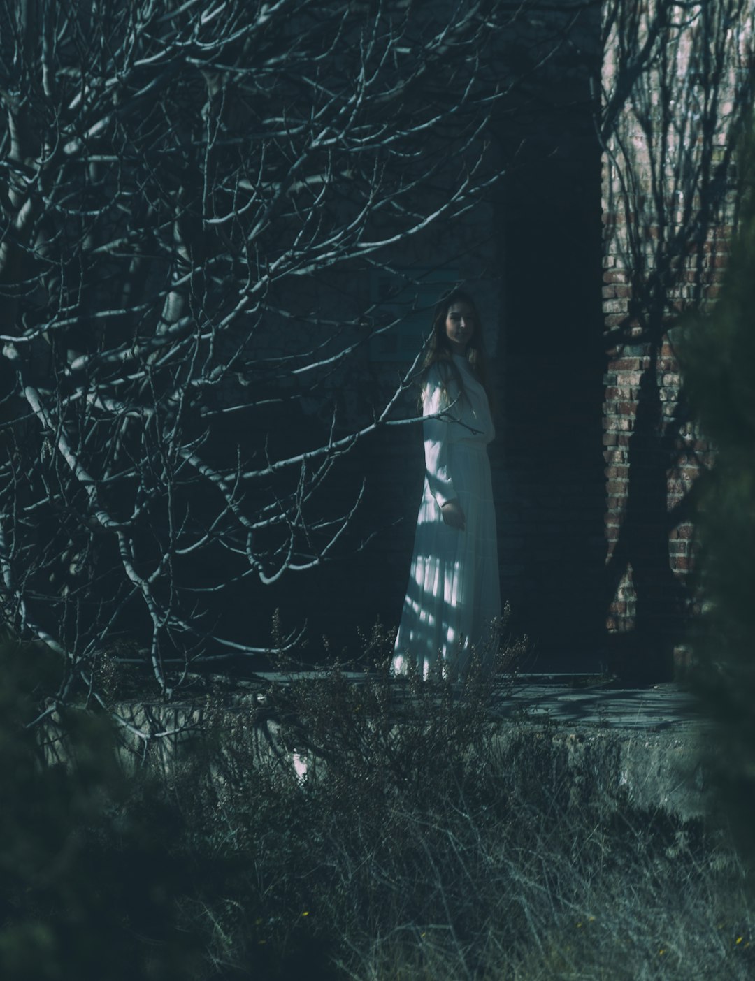 woman in white and black dress standing on forest during daytime