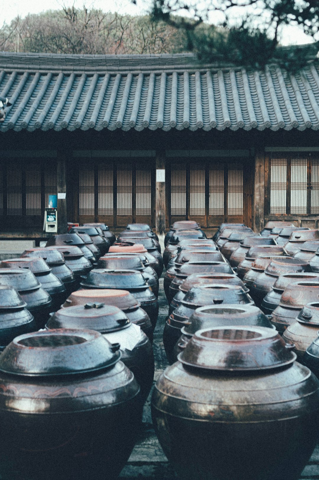 gray steel barrels on brown wooden floor