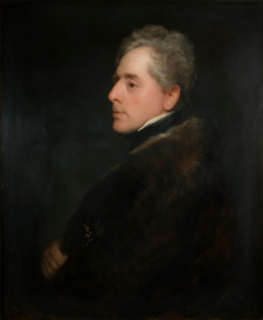 man in black and brown coat painting